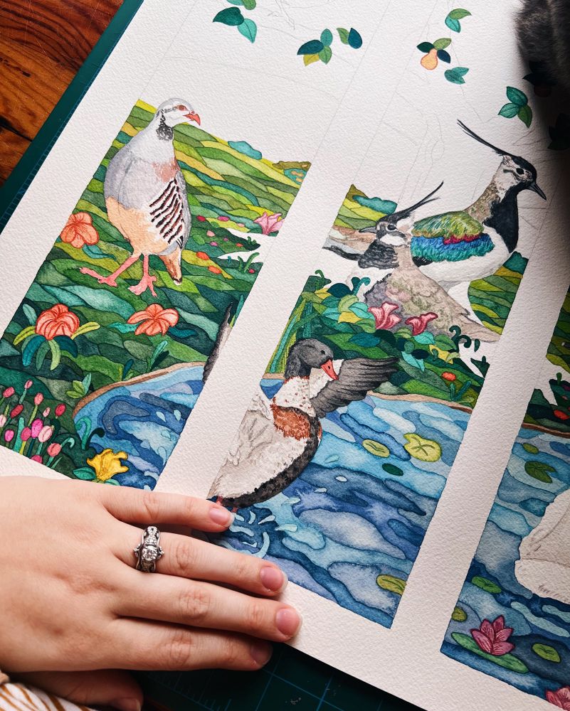 Closeup of a work-in-progress watercolor piece inspired by stained glass and featuring Irish birds 