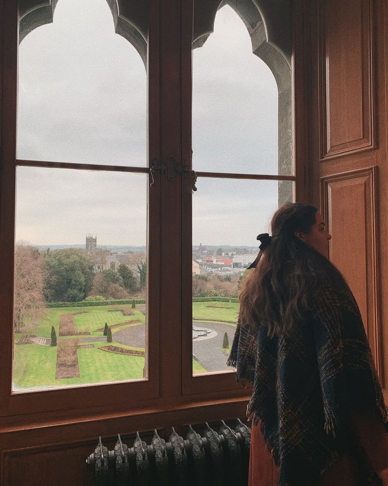 Julie at a window of Kilkenny Castle that overlooks the rose garden