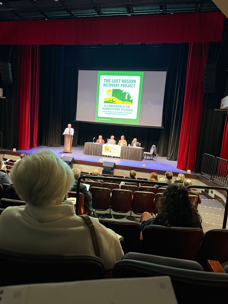 People sitting at a table on a stage 