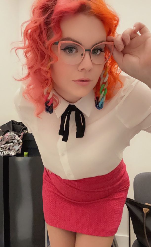 Woman with orange and pink hair with rainbow glasses chain, French handmade eyewear and pink skirt