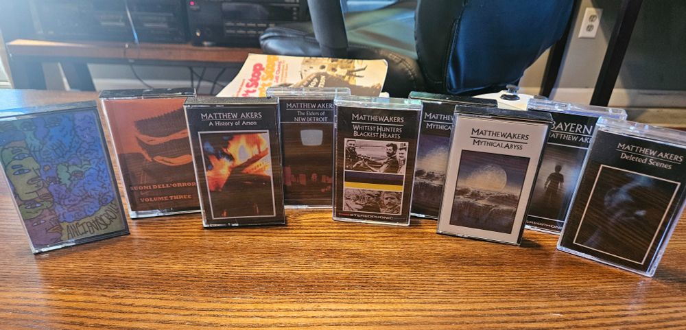 A display of 9 cassette tapes with music from the artist Matt Akers.