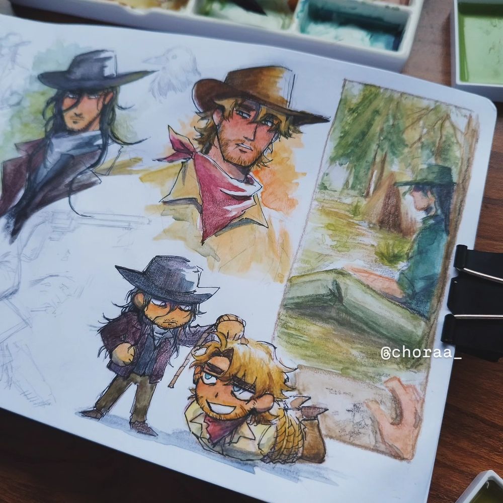 A close up photo of the sketchbook page, with a used paint palette above it and two paint pans on the corners. 

Colored headshots of two characters, Corvus and Wade in the middle.

Right features a messy sketch panel of Corvus sitting by himself while he is being sketched unknowingly. 

Bottom of the page are chibi versions of Corvus holding up a hogtied Wade.