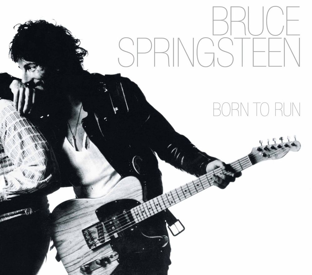 Cover of the album ‘Born to run’ by Bruce Springsteen featuring a black and white photo of Bruce in a leather jacket holding his guitar and smiling at his saxophonist, the late great Clarence Clemons