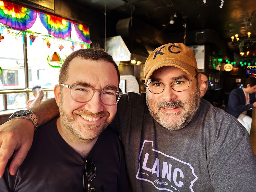 Jeff and David pose for a photo Sunday at Julius’ in NYC, a sunny gay bar decorated with pride colors.