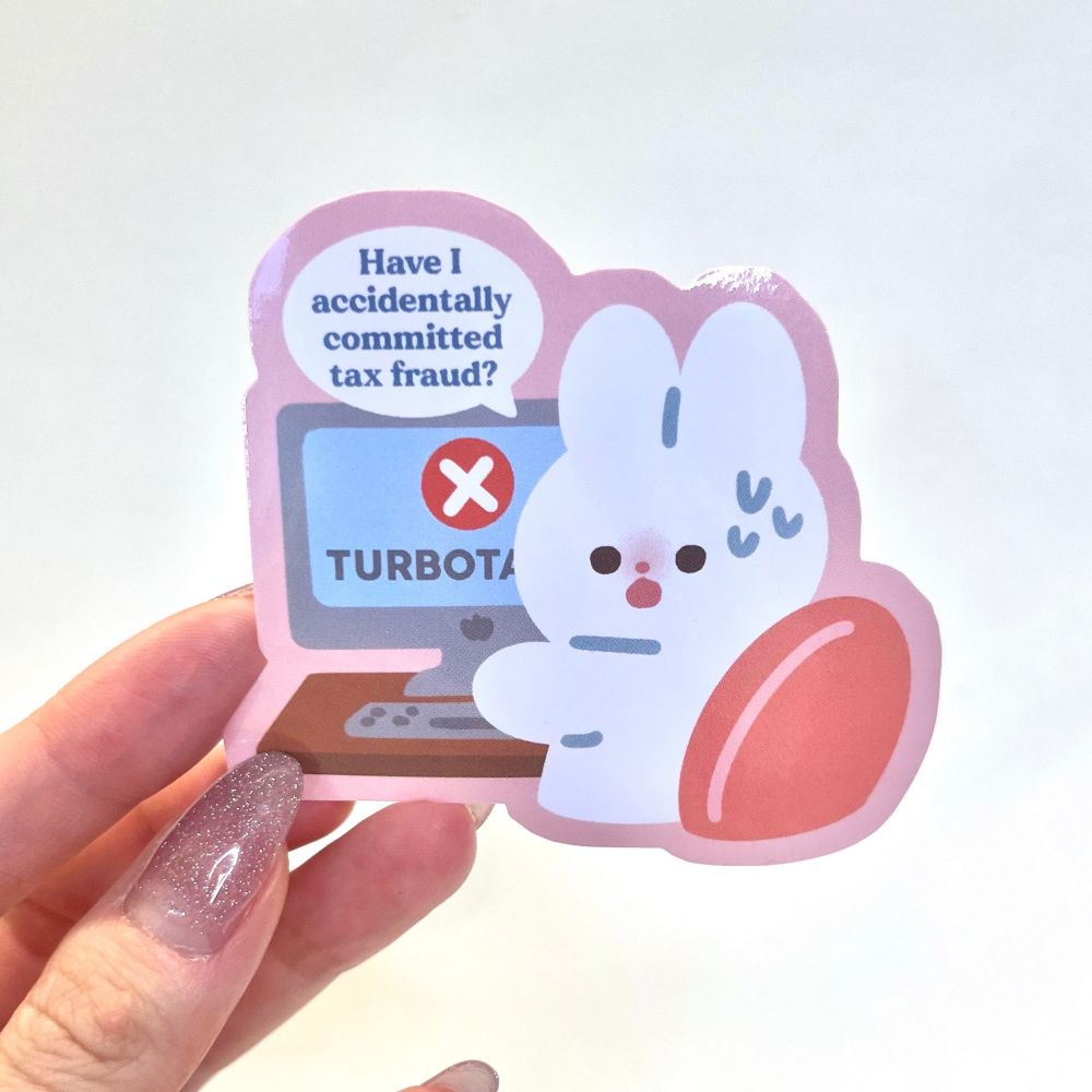 Photo of a sticker. The design is of a bunny at their computer. The screen reads “turbo tax” and the bunny is saying “have I accidentally committed tax fraud?”