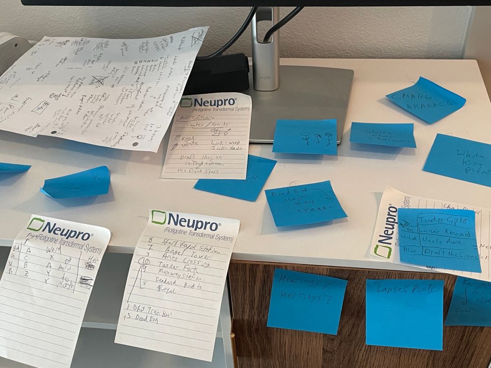 A selection of notes about Blue Prince on blue stickynotes and white notepaper