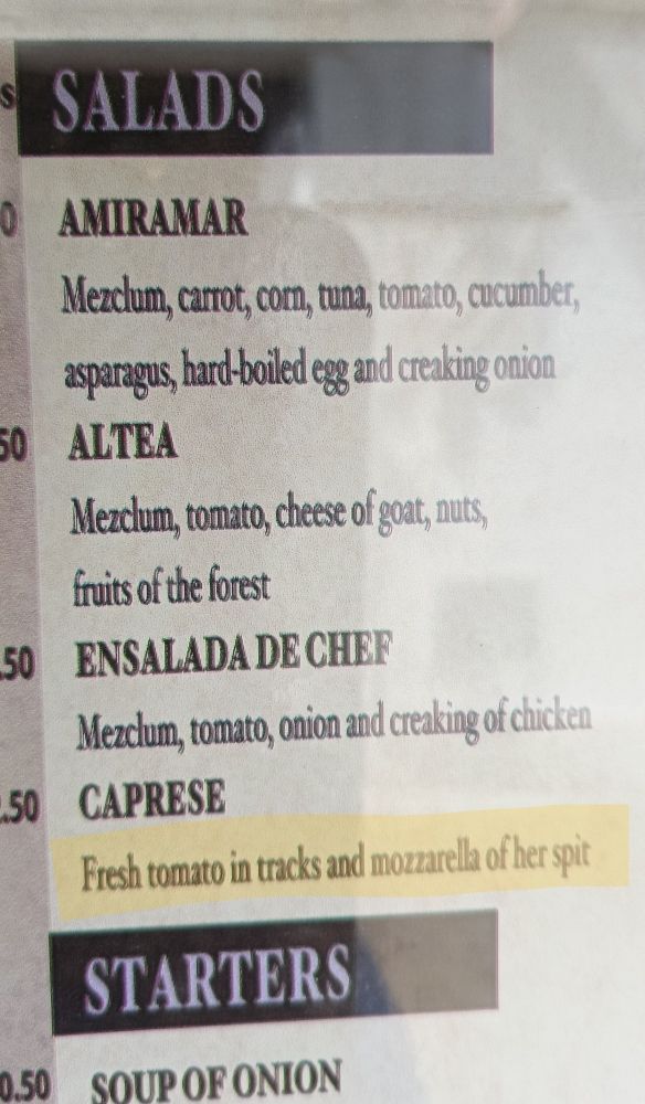 Spanish menu with Caprese salad translated as 
