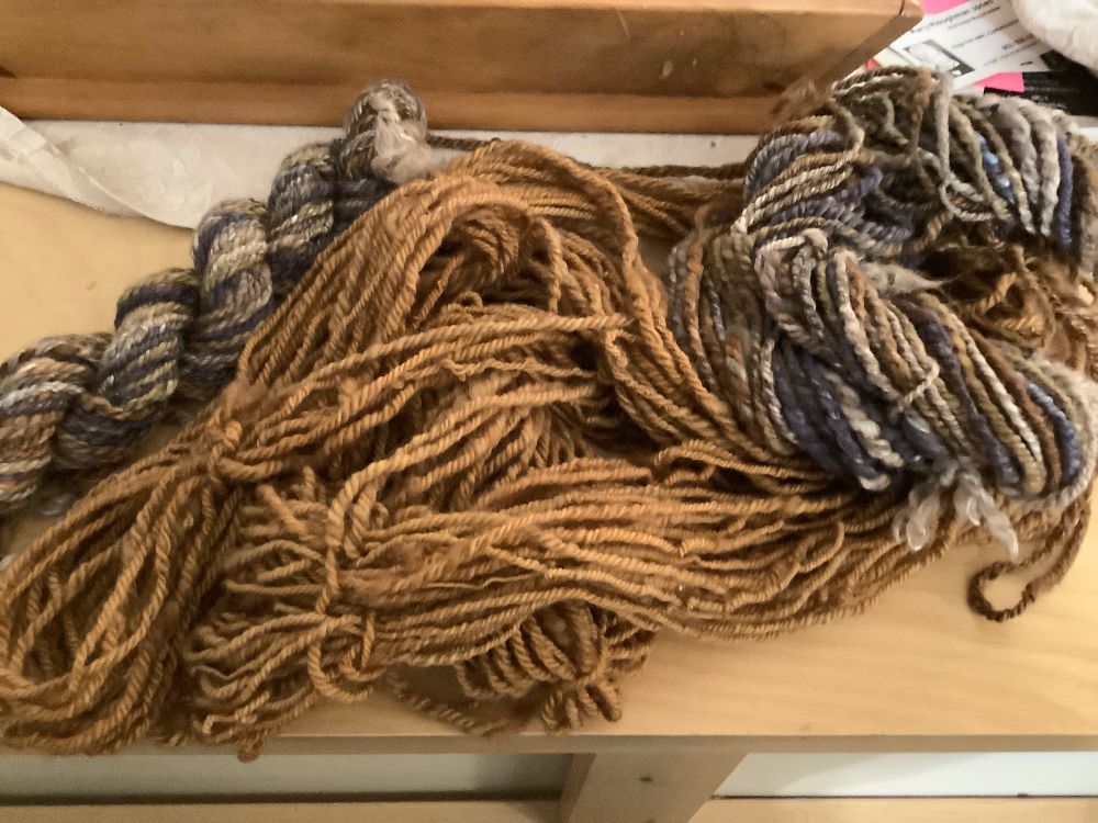 Solid golden brown yarn that doesn’t coordinate with the variegated brown/green/purple yarn in the photo.  Spot dyeing now to achieve a better match. 
