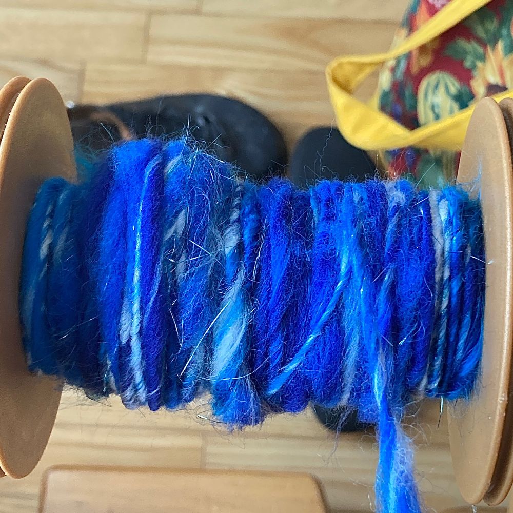 Thick and thin homespun singles in blues and blue greens, with a touch of white Tencel.