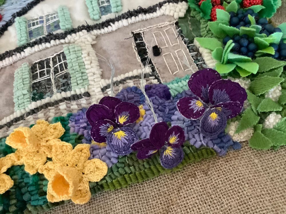 Three stumpwork pansies ready to be attached to the lower border of “The Farm”, a fibre piece created with a variety of fibre techniques.
