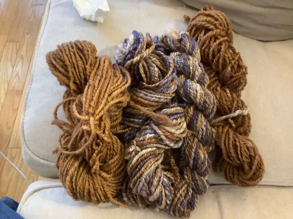 Coordinating brown skeins of home spun wool yarn, with the original home spun wool/alpaca/camel/silk variegated purple, brown and green yarn.  Can hardly see the green in this photo!  I finally got the brown wool to match a brown in the variegated yarn!