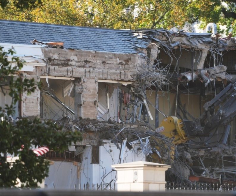 View of side of White House being demolished.