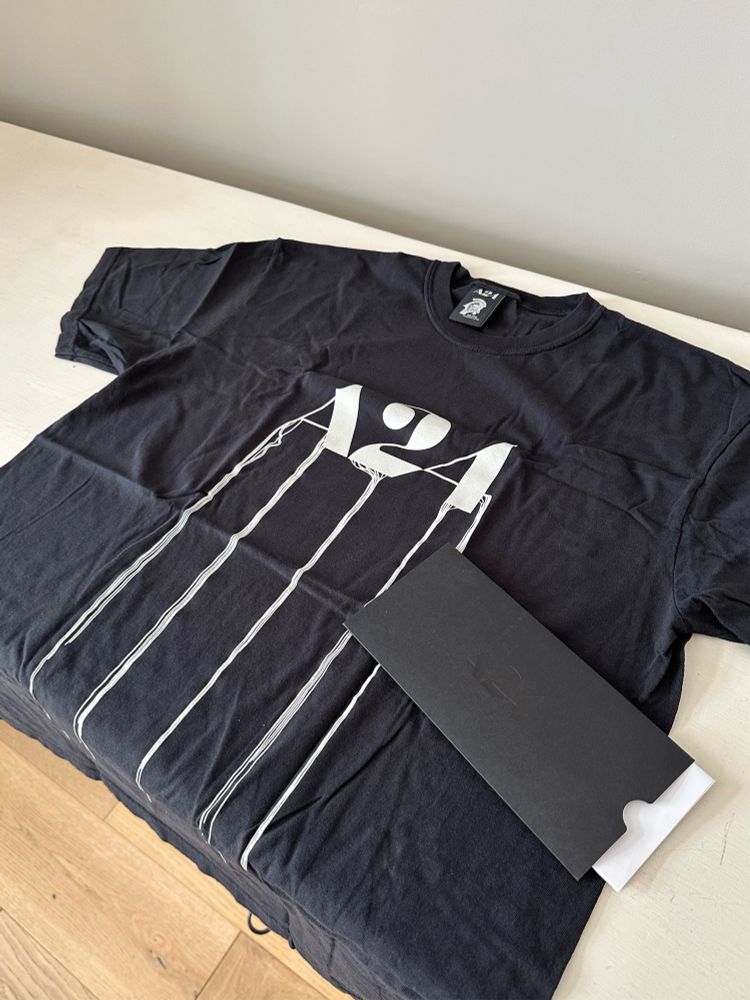 A black short sleeve T-shirt with the A24 movie studio logo in the style of death stranding. 