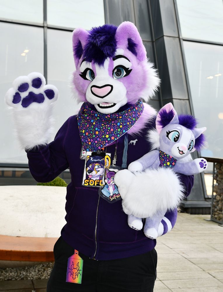 Me wearing cute lavender and purple cat fursuit partial while also holding similar plushie with matching bandana!