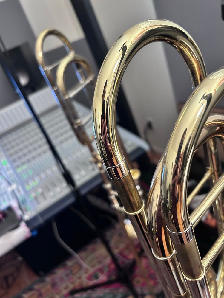 A bass trombone and tenor trombone being recorded by me.