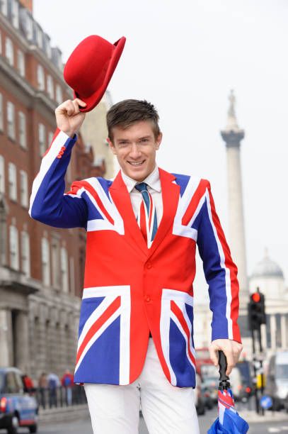 a posh arsehole wearing a Union Flag Blazer and lifting a red bowler hat, an carrying what is presumably a union flag umbrella