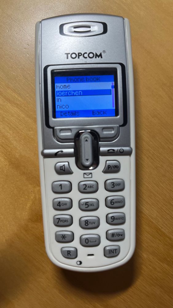 A DECT phone I use during Dutch hacker camps. It shows a phonebook entry for @jrn