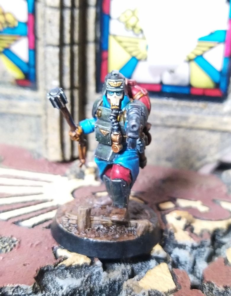 Death Korps of Krieg Mini of the Month.
Painted in roughly two days, mainly with contrast paints.
Colour scheme inspired by WWI French uniforms and WWI German body armour.
Comprises blue overcoat, red trousers, blue wraps, parkerized armour, blued pistol, dark red gas tank for brass cutting torch, plus brown leather straps, gloves and boots.
Background is GW's Chapel of Sanctuary.