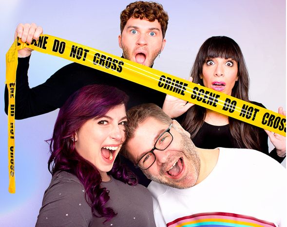Two people smiling really big open mouthed smiles while two other people smile and hold up yellow crime scene tape    in the background.