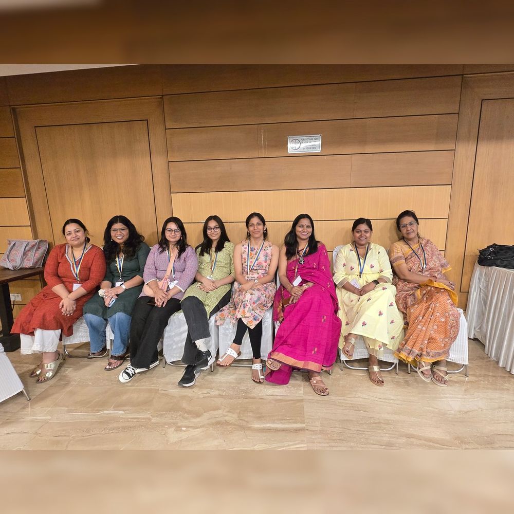 
Image of 8 CREA staff members involved in the National Consultation, sitting in a line on white chairs.