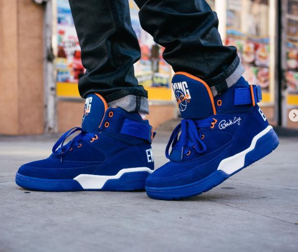 1990s vintage indigo and white Patrick Ewing gym shoes with orange trim. 