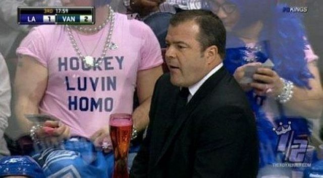 A picture of a man wearing a pink t-shirt that reads "Hockey Luvin Homo" in bold letters, each word having their line