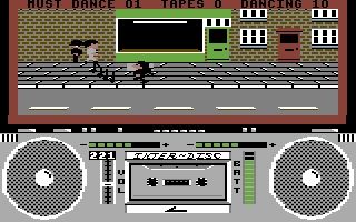 Screenshot from Commodore 64 game "Ghettoblaster". In simple 8-bit pixel graphics, top half showing a street scene with cartoonish figures, one carrying a boom box on his shoulder; bottom half a full size view of said boom box with a cassette tape playing. 