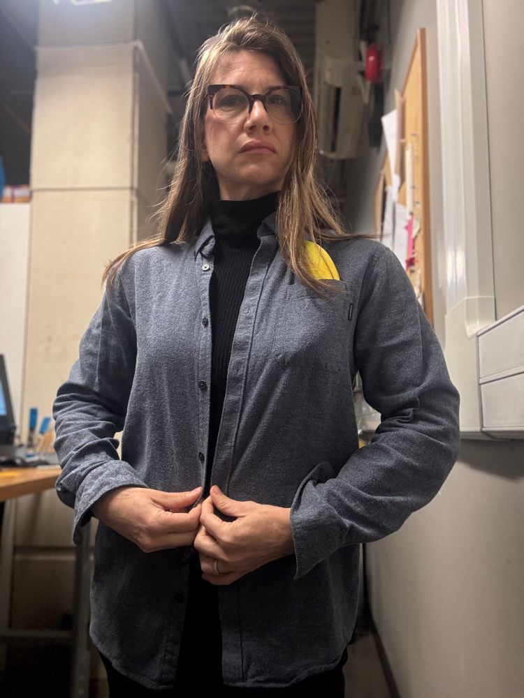Xandra looking VERY serious in a grey flannel shirt and a banana in her breast pocket.