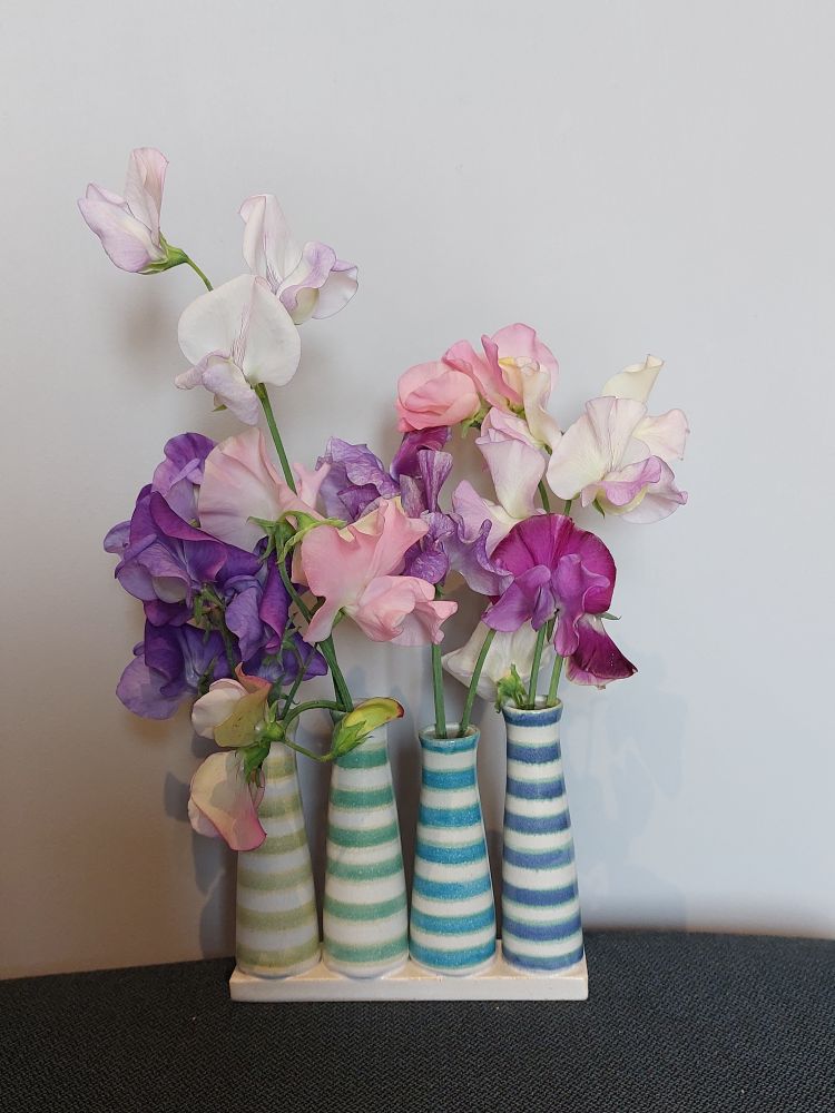 A vase with sweet peas.