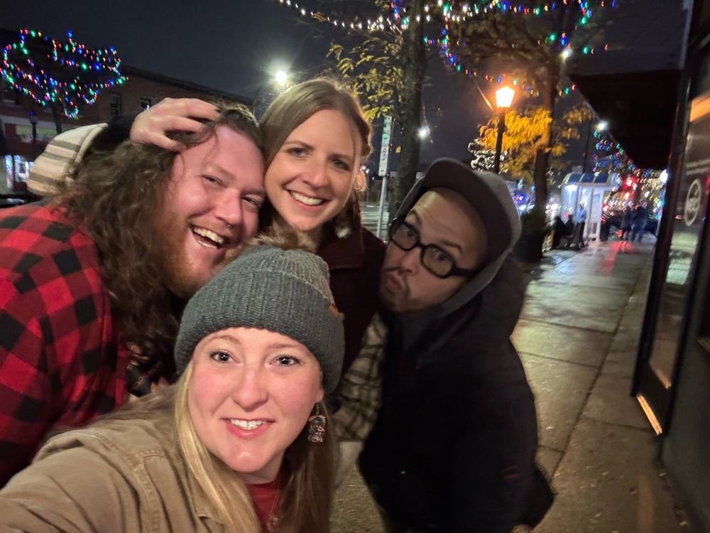 Four friends enjoying life outside a brewery 

