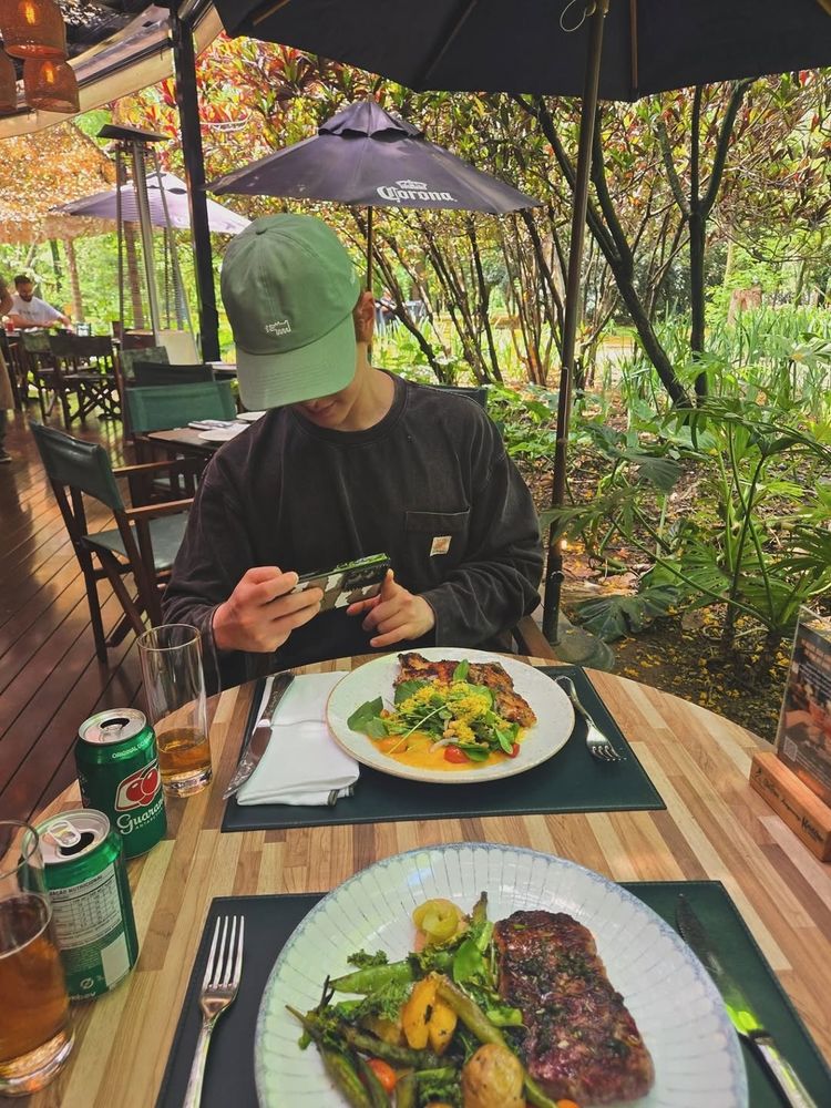 Jinki taking a picture of his food before eating