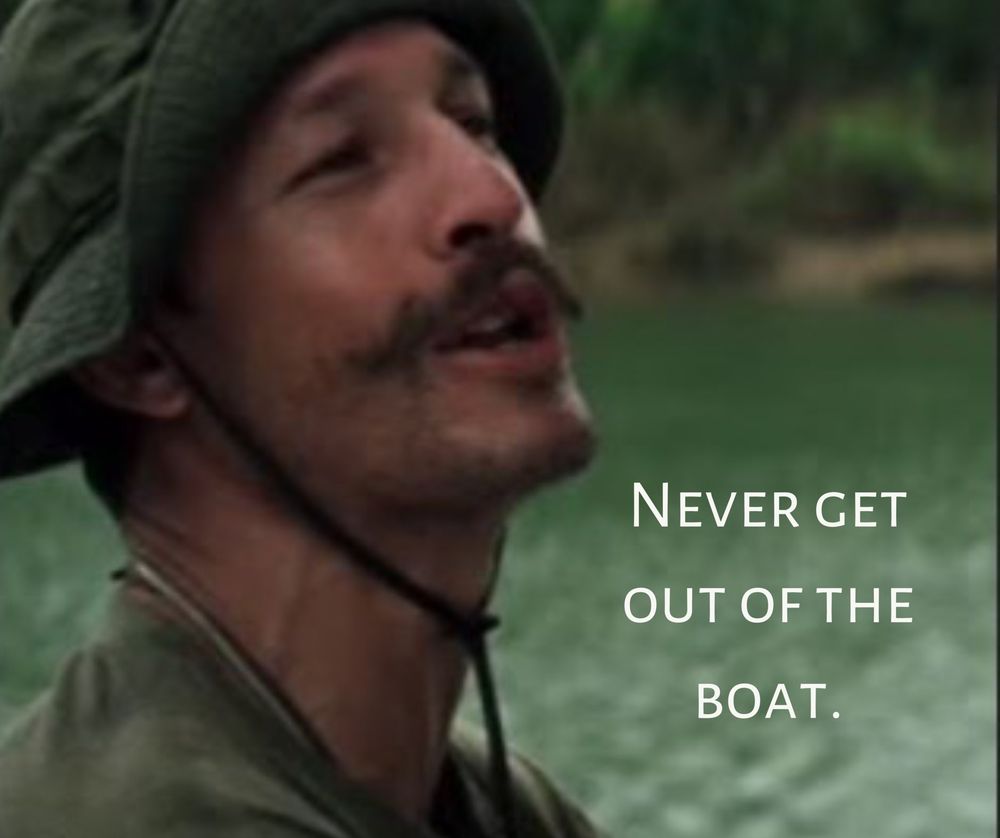 A man in army green wearing a boonie hat with text reading "Never get out of the boat." (From Apocalypse Now)