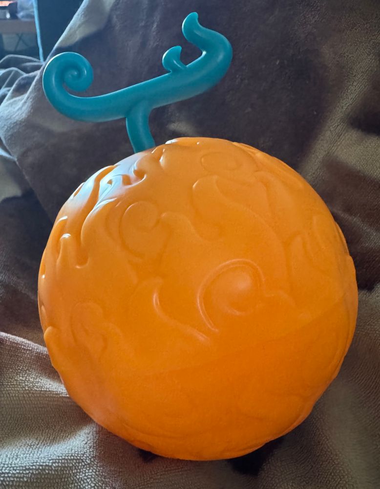 The Flame Flame Fruit from one piece 

A round fruit with flame like patterns across it 