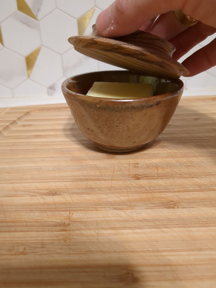 surprise! the lid is lifted gently and there is a quarter stick of butter in the bowl 