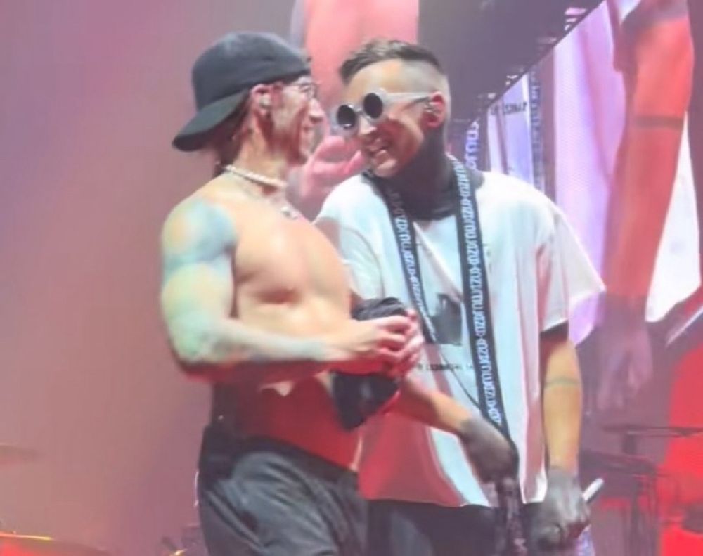 photo of tyler and josh arms linked smiling at each other