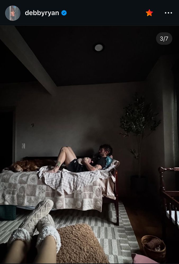 josh holding the baby on a bed