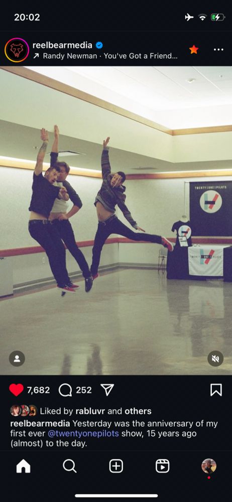 instagram post from reelbearmedia. picture is an old photo of tyler, josh and mark jumping in the air with one arm up each, in front of a merch stand with twenty one pilots merch. the caption says "Yesterday was the anniversary of my first ever @twentyonepilots show, 15 years ago (almost) to the day." the post is tagged with the song "you've got a friend in me" by randy newman