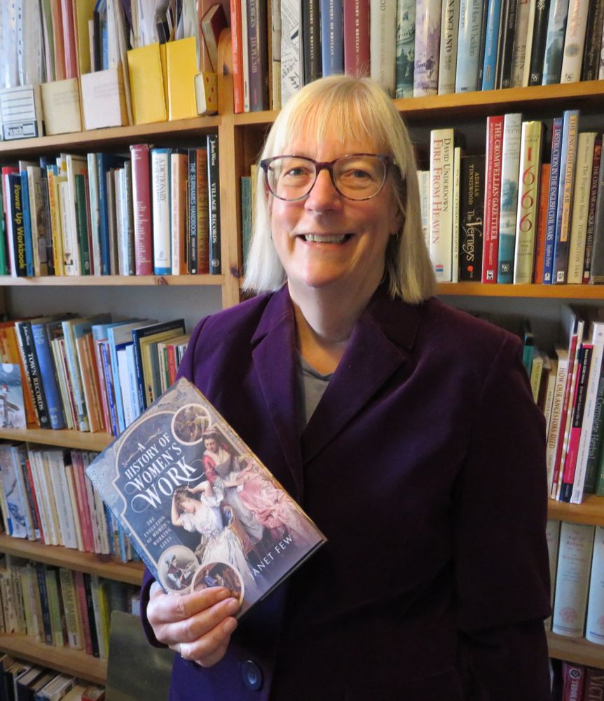 Author holding a copy of A History of Women's Work
