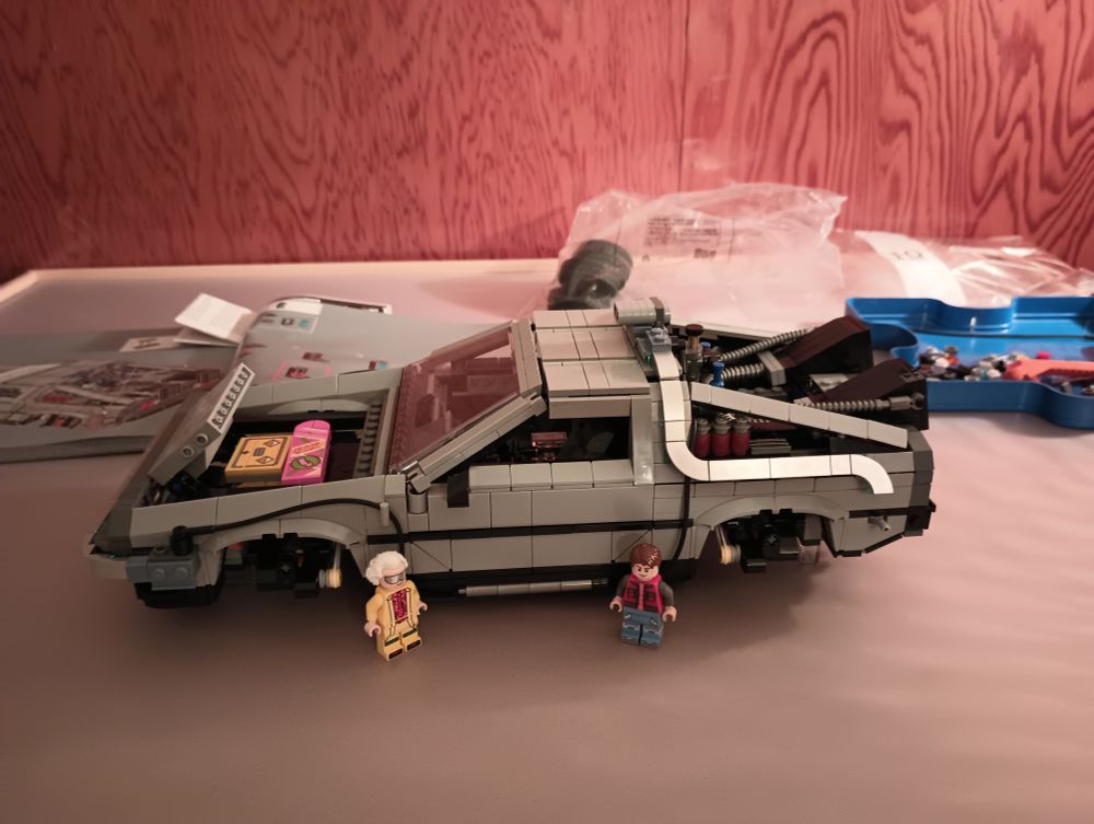 Partially built Lego model of the Delorean time machine from Back to the Future with Doc and Marty minifigs 