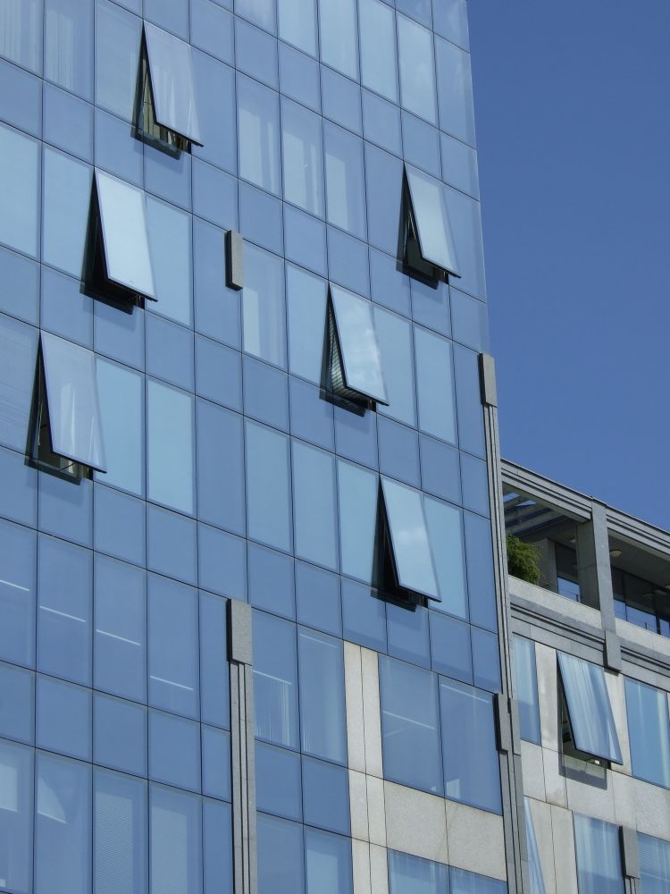 Blue and grey buildings against a blue sky.
