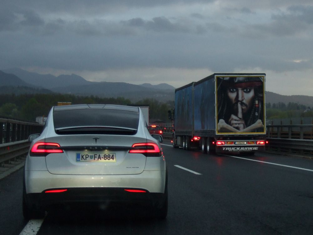 Cars and trucks in a traffic jam on the highway.