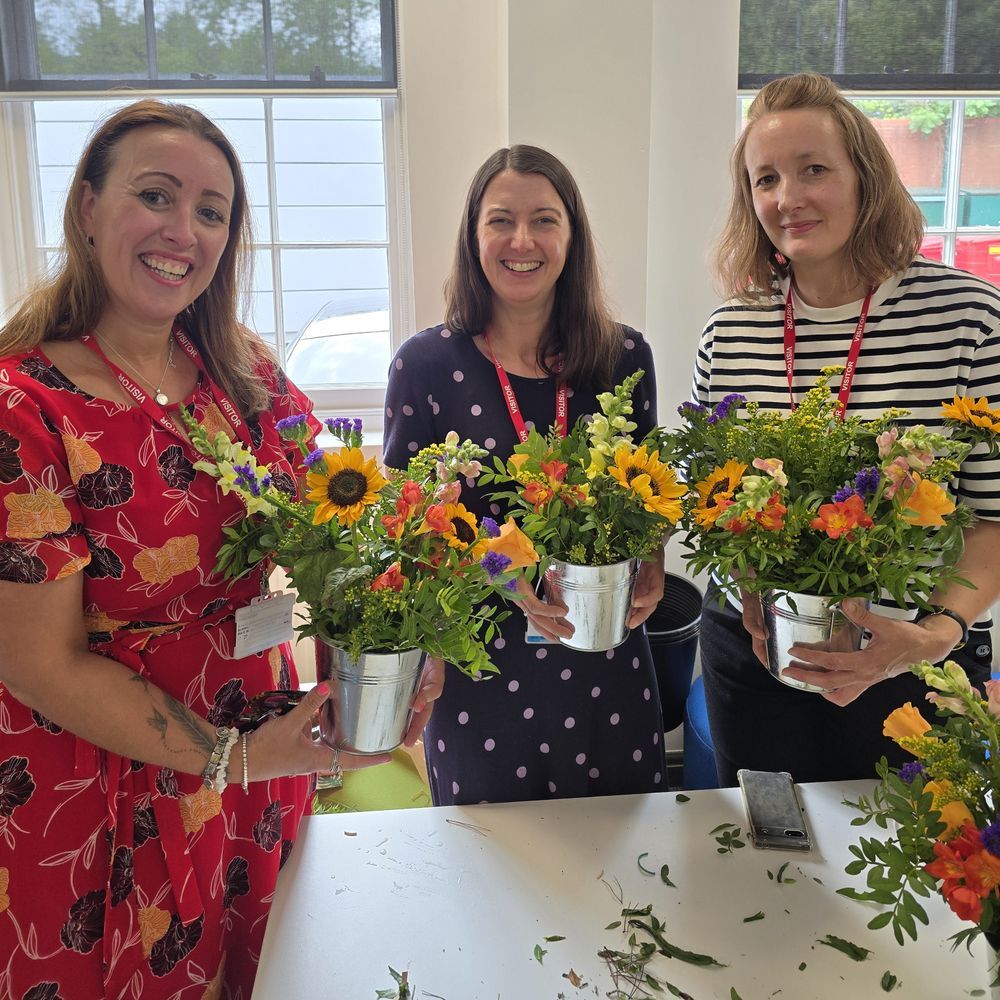 Nicola, Colette from b:friend and Becky smiling with their flower arrangements
