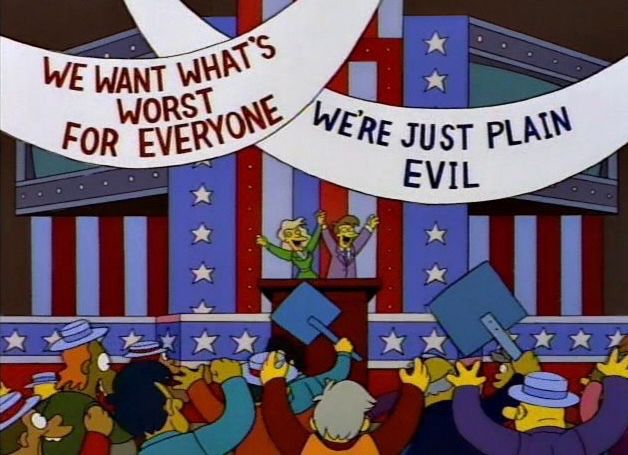 Frame from a 1994 Simpsons episode showing a Republican convention with cheering participants and banners stating “we want what’s worst for everyone” and “we’re just plain evil”.