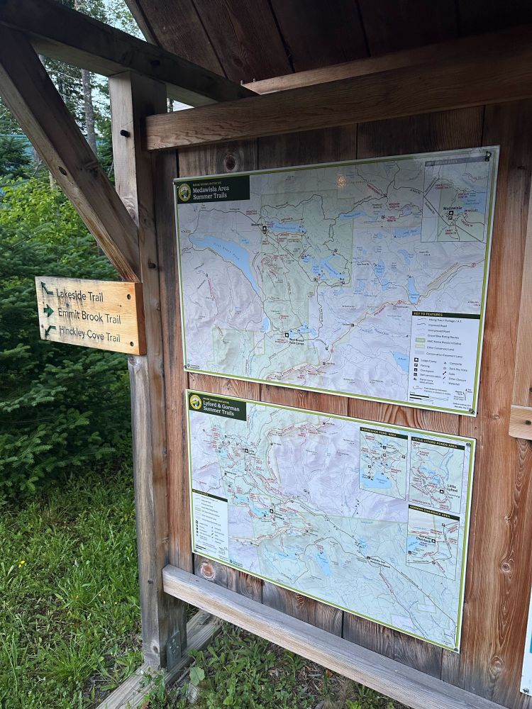 Photo of two hiking trail maps on an information kiosk.