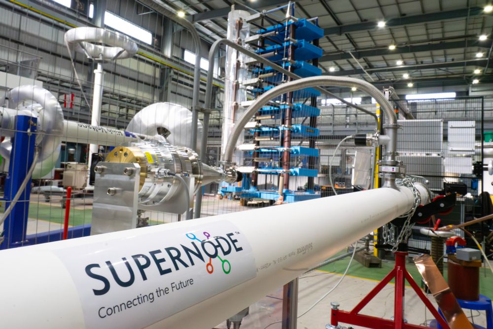 SuperNode's superconducting cable undergoing testing at ORE Catapult. The cable is in the bottom of the image, with various futuristic looking testing machines in the background.