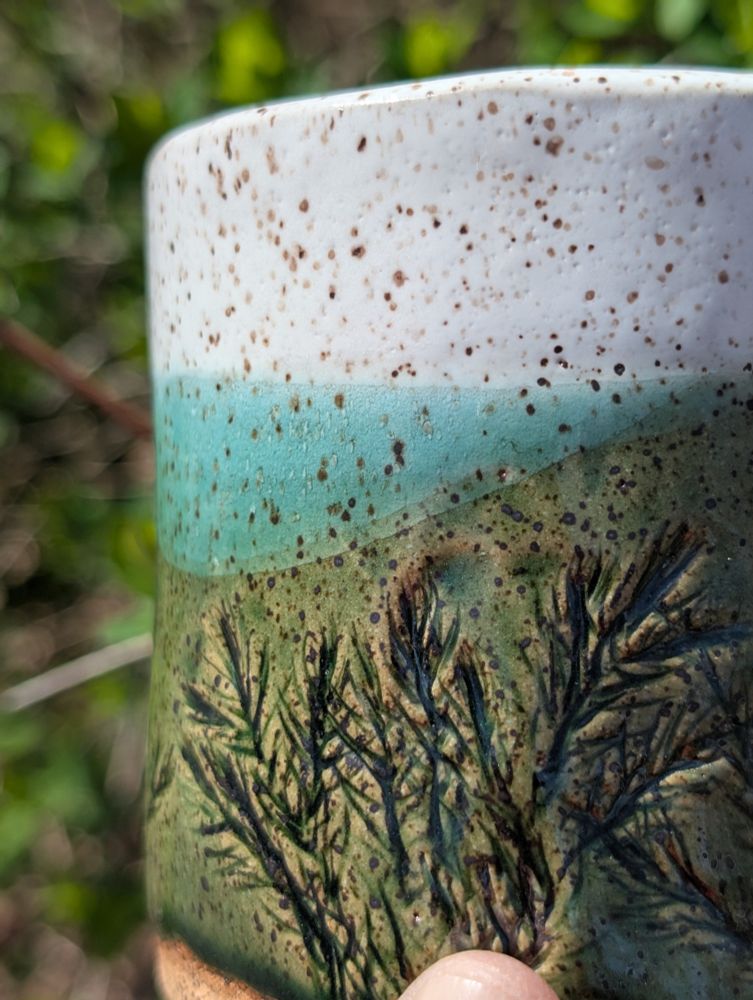 A hand built mug, showing glaze detail