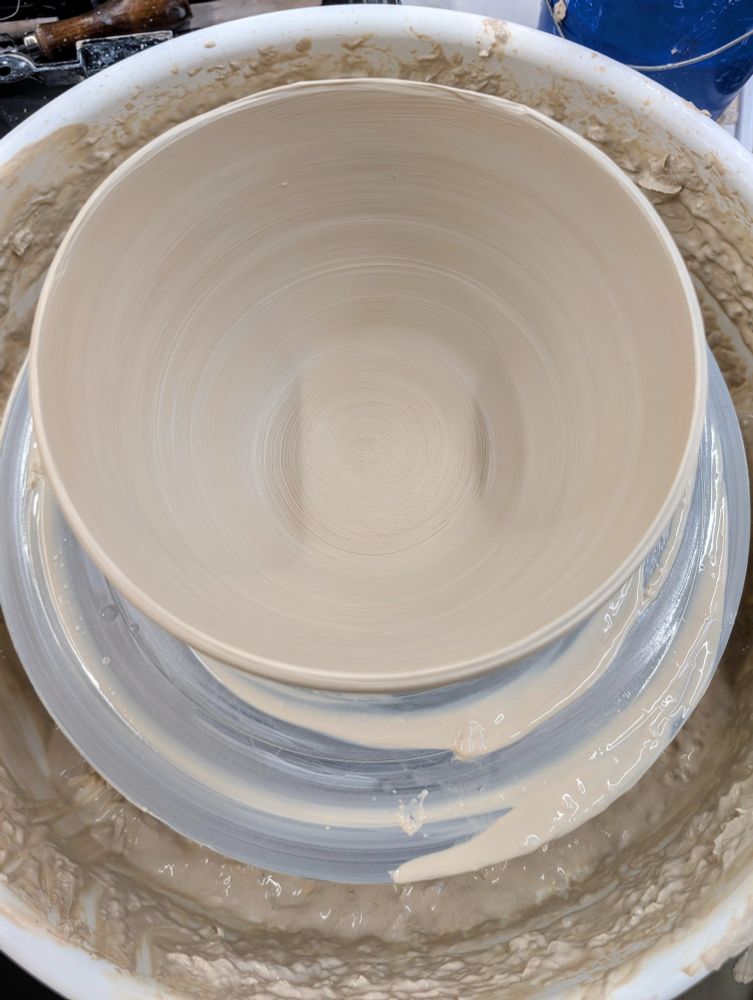 A fairly large white stoneware bowl I have just thrown, still on the pottery wheel