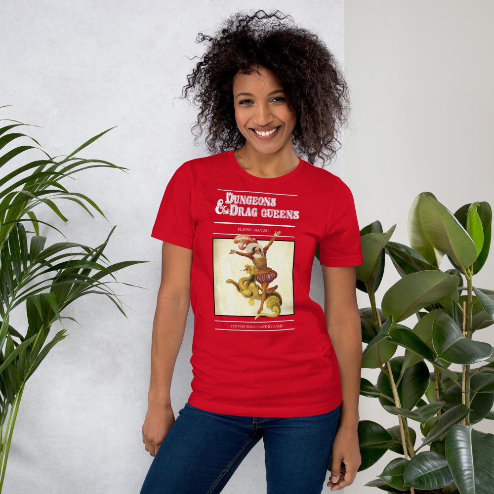 Woman wearing a red t-shirt with a flamboyant medieval person on and Dungeons and Drag Queens on it. 