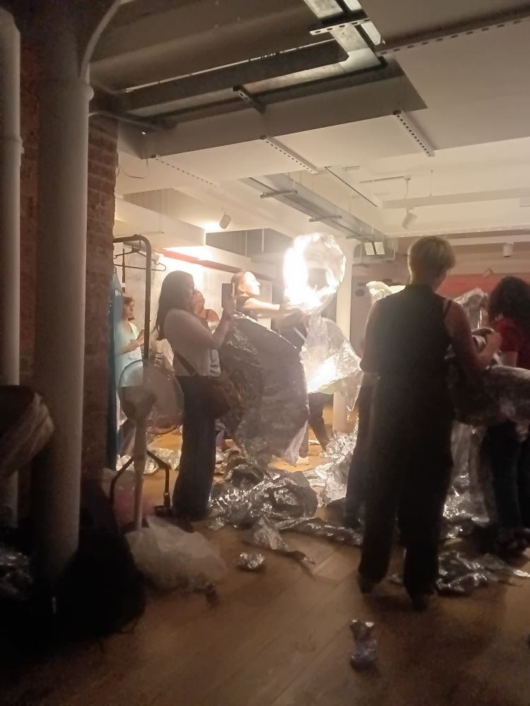Dancers with foil in a studio