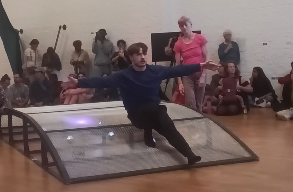 Ancer balancing on a brdge sculpture in an art gallery